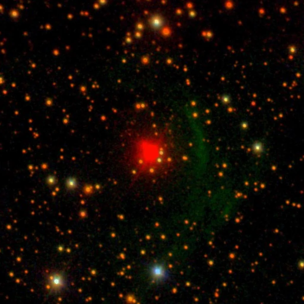 NML Cygni brilla en rojo y está rodeada por un arco verdoso de material expulsado.